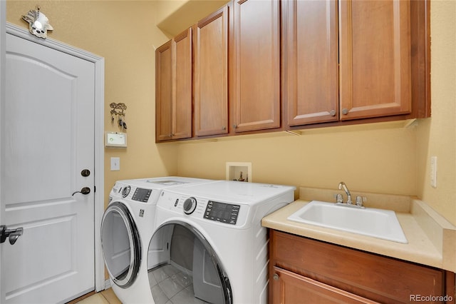 washroom featuring cabinets, washing machine and dryer, tile patterned floors, and sink