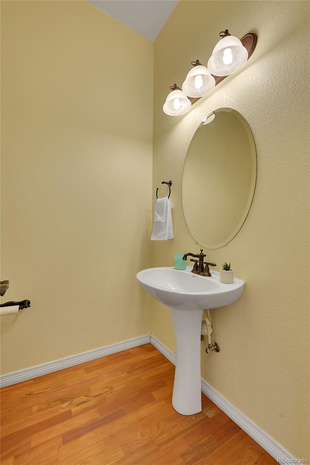 bathroom with hardwood / wood-style flooring