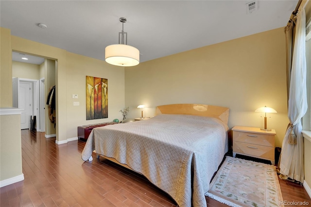 bedroom with dark wood-type flooring