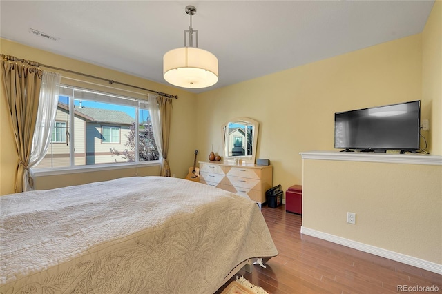 bedroom with hardwood / wood-style flooring