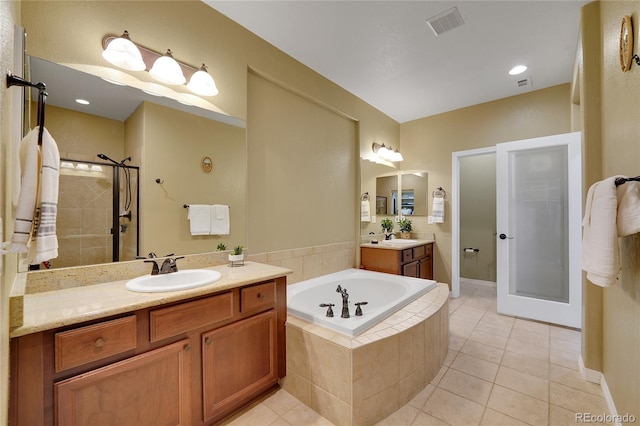 bathroom with tile patterned flooring, shower with separate bathtub, and vanity