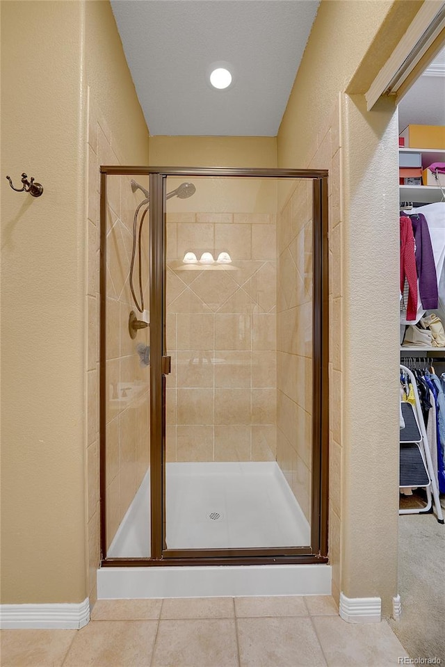 bathroom with tile patterned floors and walk in shower