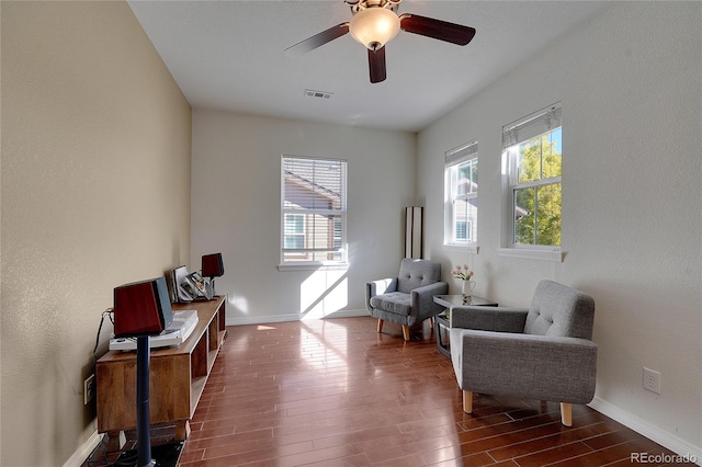 sitting room with dark hardwood / wood-style floors and ceiling fan