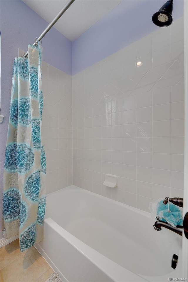 bathroom with tile patterned flooring and shower / bathtub combination with curtain