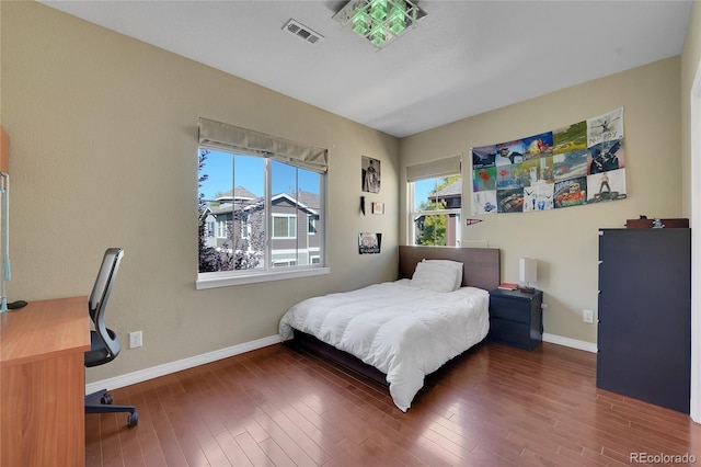 bedroom with dark wood-type flooring