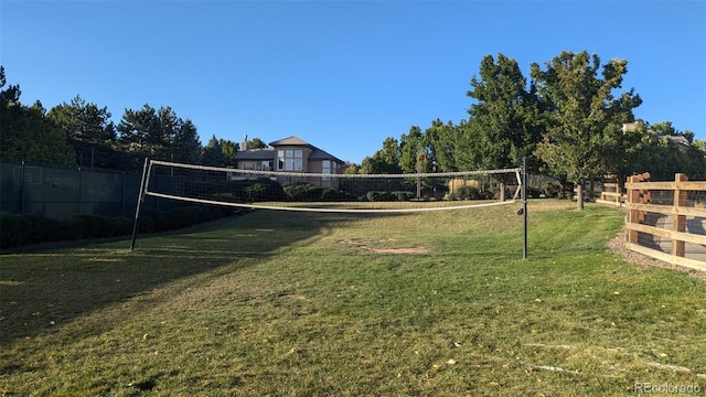 surrounding community with volleyball court and a yard