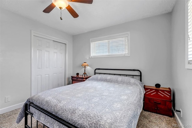 bedroom with carpet flooring, baseboards, a closet, and ceiling fan
