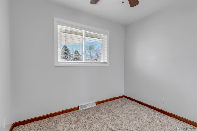 unfurnished room with baseboards, ceiling fan, and carpet floors