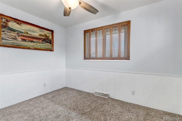 spare room featuring carpet and a ceiling fan