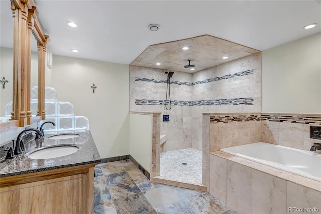 full bathroom with a bath, a walk in shower, recessed lighting, baseboards, and double vanity