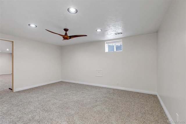 carpeted spare room featuring recessed lighting, a ceiling fan, and baseboards