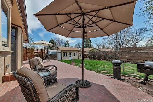 view of patio with an outbuilding and outdoor dining space