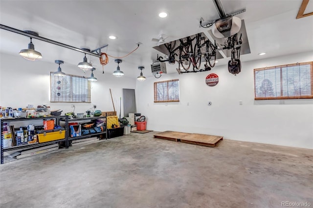 garage featuring a workshop area, recessed lighting, and a garage door opener