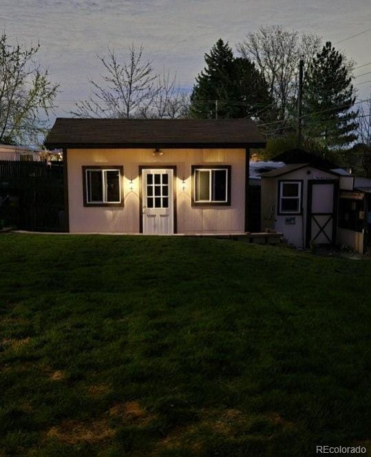 view of front facade featuring a shed and an outbuilding