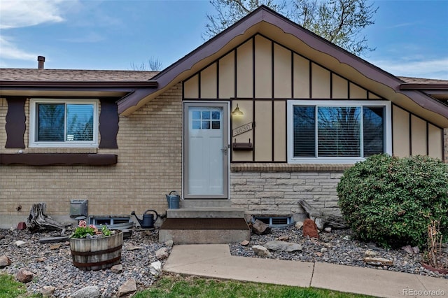view of front of house with board and batten siding and brick siding