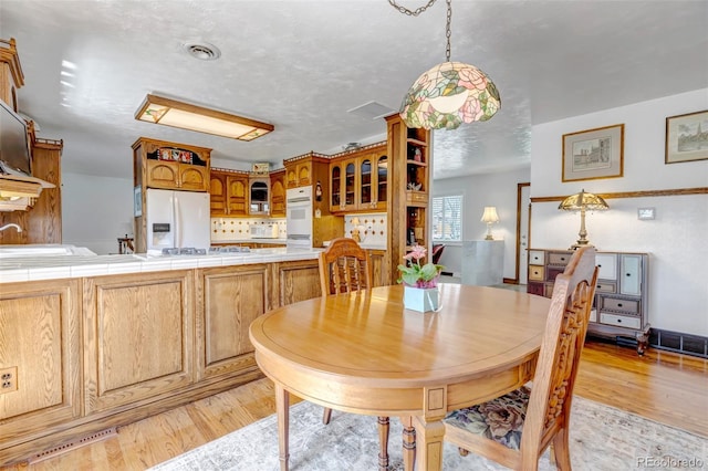 dining room with light wood-style flooring