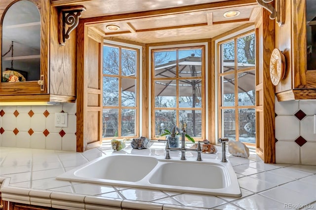 kitchen view of a sink and tile counters
