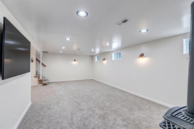 below grade area with recessed lighting, carpet floors, stairs, baseboards, and plenty of natural light