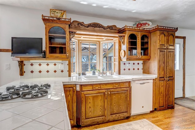 3630 W Saratoga Ave, Littleton, CO 80123 - kitchen featuring white appliances, backsplash, glass insert cabinets, and light wood finished floors