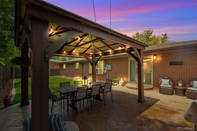 12256 W 34th Pl, Wheat Ridge, CO 80033 - patio terrace at dusk featuring a gazebo, a patio, and outdoor dining space