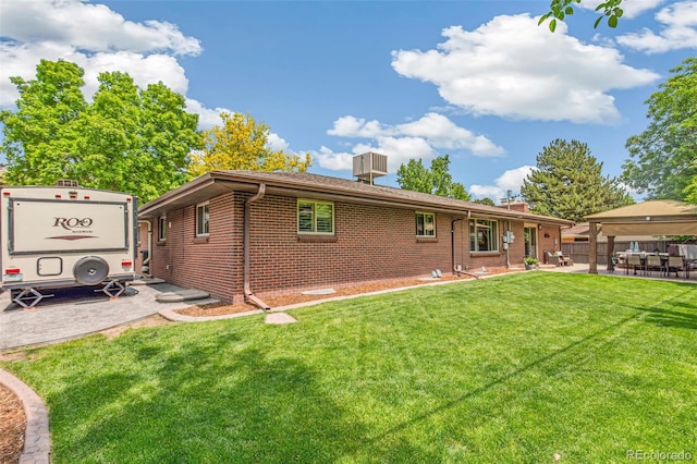 12256 W 34th Pl, Wheat Ridge, CO 80033 - rear view of property featuring brick siding, a chimney, and a patio area