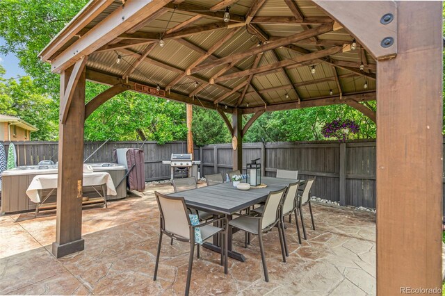 12256 W 34th Pl, Wheat Ridge, CO 80033 - fenced backyard with a gazebo, a patio area, a grill, and outdoor dining area