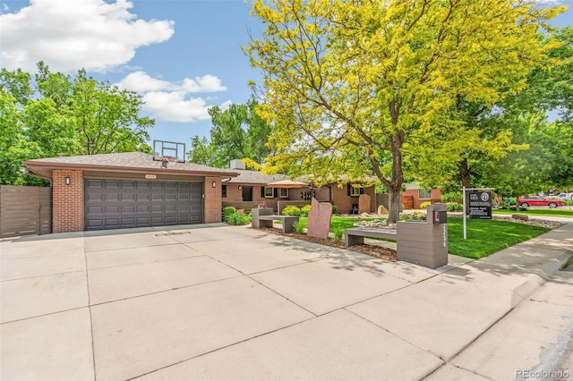 12256 W 34th Pl, Wheat Ridge, CO 80033 - view of front of home featuring brick siding, an attached garage, concrete driveway, and roof with shingles