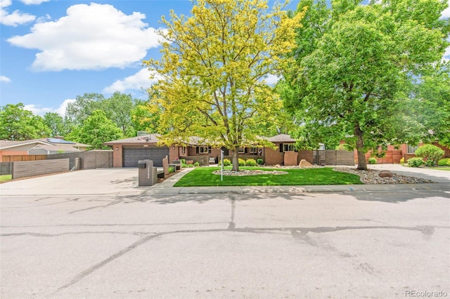 12256 W 34th Pl, Wheat Ridge, CO 80033 - view of front of house with concrete driveway, a garage, brick siding, and a gate