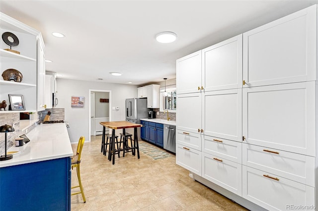 12256 W 34th Pl, Wheat Ridge, CO 80033 - kitchen with open shelves, tasteful backsplash, blue cabinets, appliances with stainless steel finishes, and white cabinets