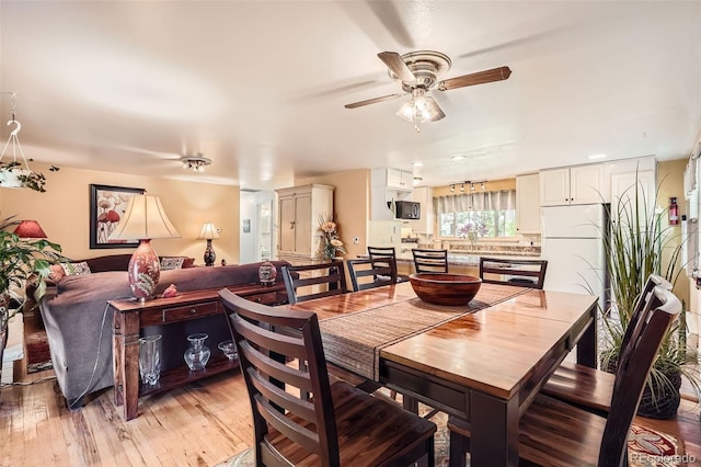 6940 W 63rd Ave, Arvada, CO 80003 - dining space with ceiling fan and light wood-style flooring