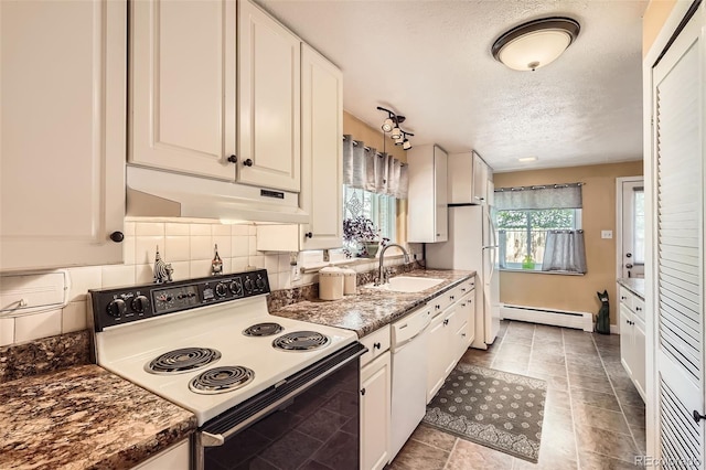 6940 W 63rd Ave, Arvada, CO 80003 - kitchen with white appliances, a baseboard heating unit, under cabinet range hood, a textured ceiling, and white cabinetry