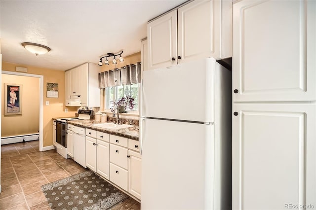 6940 W 63rd Ave, Arvada, CO 80003 - kitchen featuring white appliances, a baseboard heating unit, white cabinets, and dark stone counters