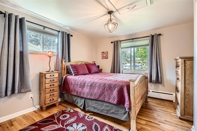 6940 W 63rd Ave, Arvada, CO 80003 - bedroom with baseboard heating and light wood finished floors