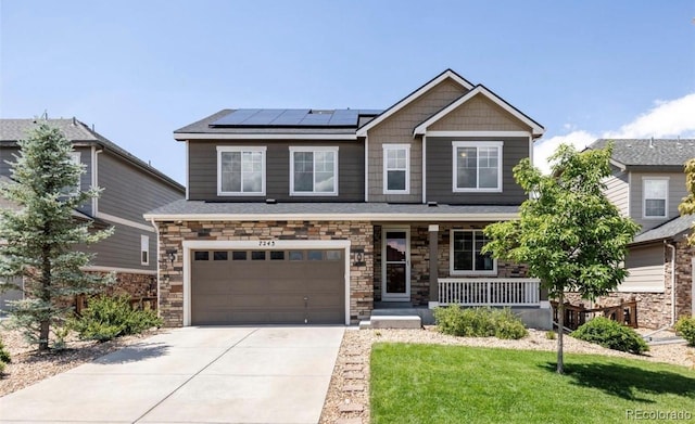 craftsman inspired home with a garage, a front yard, covered porch, and solar panels