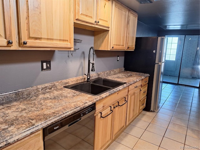 3550 S Harlan St Unit 313, Denver, CO 80235 - kitchen with black dishwasher, light brown cabinetry, a sink, and light tile patterned floors