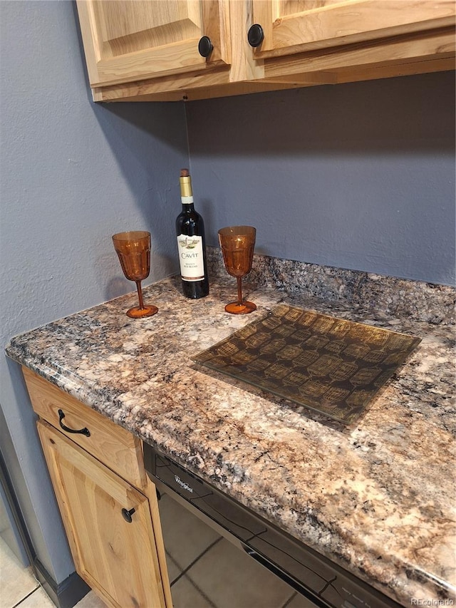 3550 S Harlan St Unit 313, Denver, CO 80235 - detailed view of light brown cabinets, dishwasher, and dark stone countertops