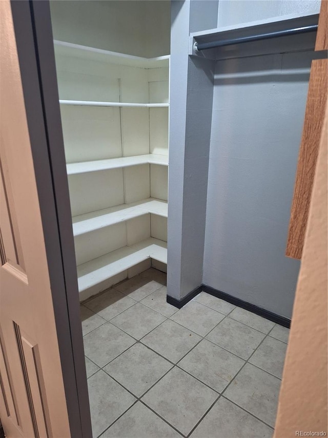 spacious closet featuring light tile patterned flooring