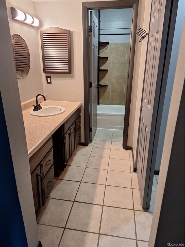 bathroom with vanity, washtub / shower combination, and tile patterned floors