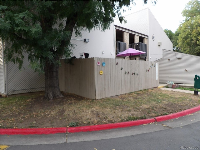 view of side of property with a balcony