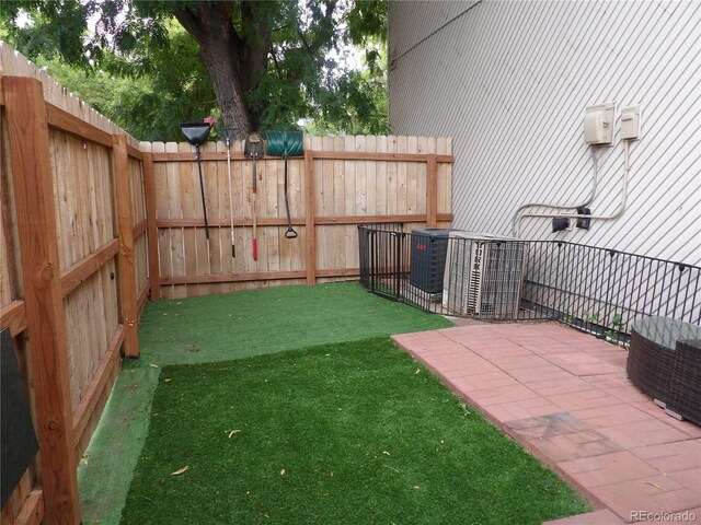 view of yard featuring central air condition unit and fence private yard