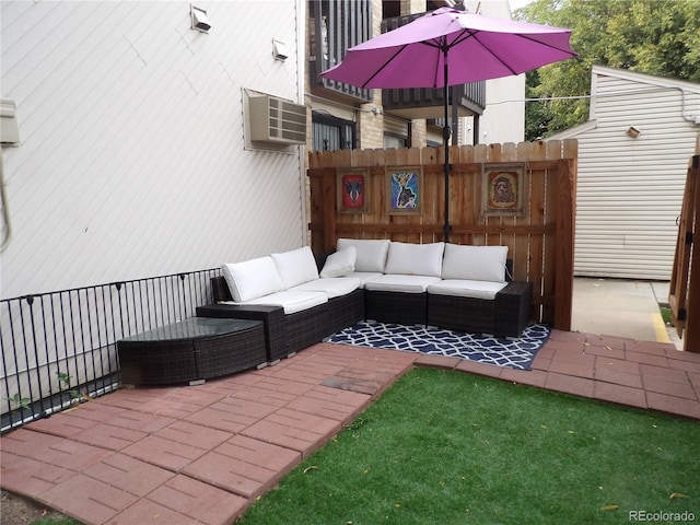 3550 S Harlan St Unit 313, Denver, CO 80235 - view of patio with an outdoor living space and a wall unit AC