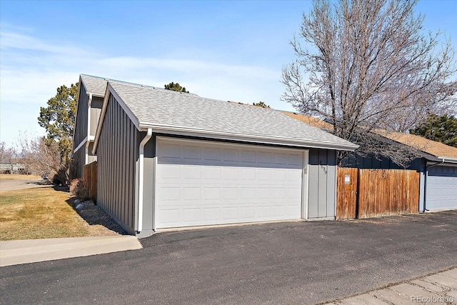 detached garage featuring fence