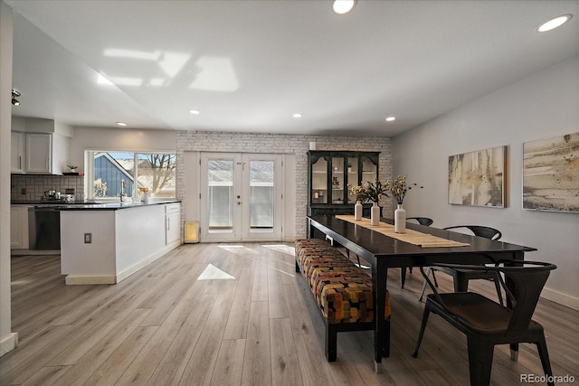 dining area featuring light wood-type flooring, french doors, and recessed lighting