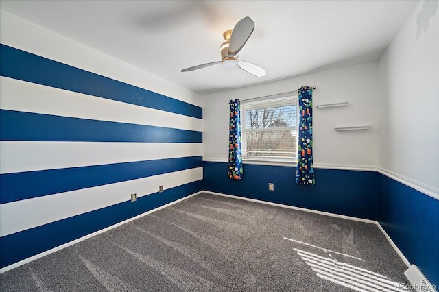 empty room with ceiling fan, baseboards, and carpet flooring