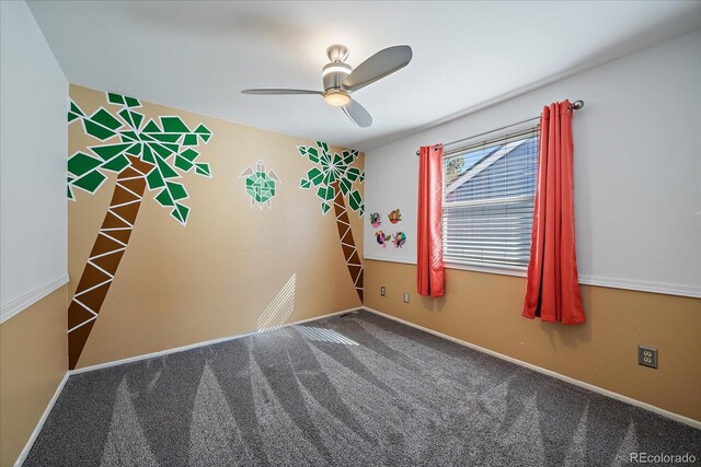 spare room featuring carpet floors, baseboards, and a ceiling fan