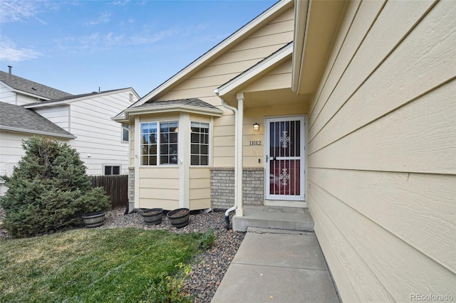 property entrance with a lawn