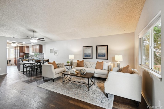 living room featuring dark hardwood / wood-style flooring and a textured ceiling