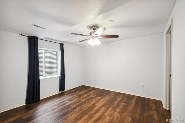 unfurnished room with dark hardwood / wood-style flooring, a textured ceiling, and ceiling fan