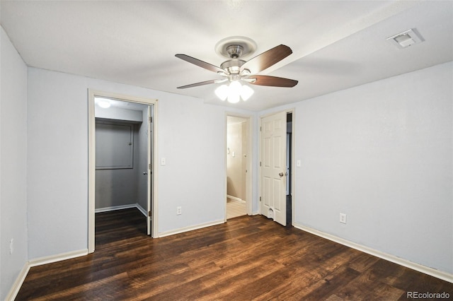 empty room featuring ceiling fan and dark hardwood / wood-style flooring