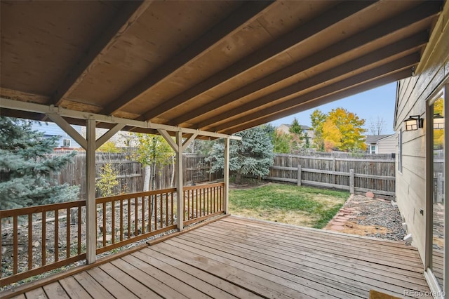 wooden deck featuring a lawn